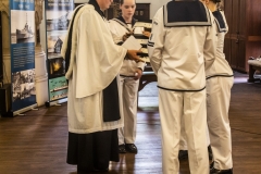 Rector Patrick King collects the offerings from the cadets.